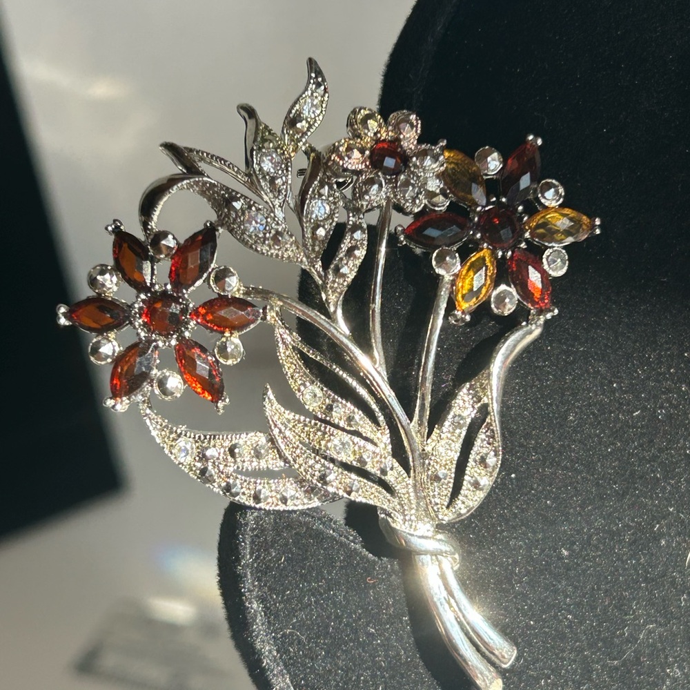 Silver-tone brooch with amber colored and clear rhinestones flower bouquet